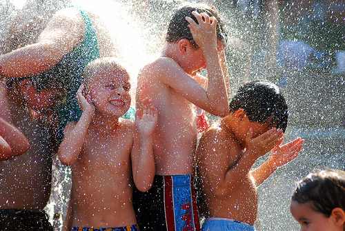 Kids playing in the Crowne Fountain, Minenium Park, Chicago. Photo courtesy of Kymberly Janisch at Flickr.