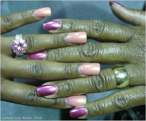 2 women's hands with nail polish